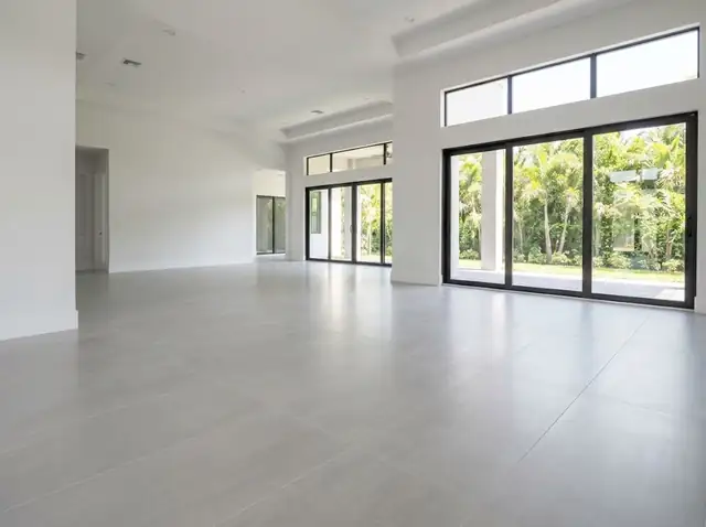 Illustration: light gray large-format tile floor in a bright open living area